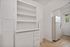 Charming kitchen with vintage built-in cabinetry and classic white appliances, perfect for storage and functionality.