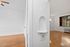 Elegant apartment interior showcasing smooth wooden floors, large window with natural light, and charming architectural niche in vibrant living space.