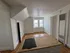 Bright, cozy room with sloped ceiling and double windows, featuring hardwood floors and white walls, perfect for a compact living space.