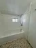 Cozy bathroom featuring a clean bathtub, elegant showerhead, and charming mosaic tile flooring.