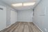 Bright, freshly remodeled room with elegant wood flooring and soft gray walls, perfect for a cozy living space.