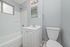 Modern bathroom with sleek fixtures, a clean white bathtub, and a contemporary vanity set against a stylish gray wall.