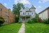 Charming Victorian-style house with elegant turret, inviting front porch, and lush green lawn, perfect for family living.
