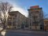 Elegant historic apartment building with classic architecture and natural surroundings.