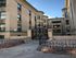 Inviting historic apartment facade with elegant brickwork and decorative iron gate entrance.