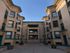 Elegant brick apartment building with classic architectural details and a welcoming walkway.
