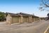 Row of modern residential garages with stylish brick accents and clean, paved driveways.