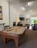 Chic lounge area featuring a stylish pool table, contemporary seating, and a modern fireplace.