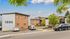 Inviting apartment complex with brick exteriors, surrounded by lush greenery and ample parking space.