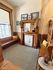 Cozy corner featuring a vintage wooden bench, elegant fireplace, and stylish photo decor.