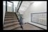 Bright and inviting apartment stairwell featuring modern railing and convenient mailboxes, promising a welcoming entrance.