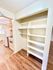 Modern kitchen with elegant wooden flooring and ample shelving, perfect for organized living and culinary creativity.
