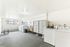 Bright and spacious laundry room featuring modern washers, dryers, and ample lockers for storage.