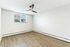 Bright and inviting empty room with sleek wooden floors and a modern ceiling fan, perfect for personalization.