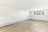 Bright and spacious empty room with elegant hardwood floors and large windows, perfect for customization.
