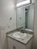 Modern bathroom vanity with sleek granite countertop and elegant mirror, creating a bright and inviting space.