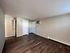 Bright, spacious room with elegant hardwood flooring and freshly painted walls, ideal for a modern living area.