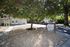 Charming Sherlock Townhomes entrance with lush greenery and inviting pathways.