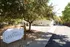 Charming Sherlock Townhomes entrance surrounded by lush greenery and peaceful pathways, perfect for idyllic living.