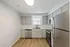 Modern kitchen with sleek stainless steel appliances, elegant cabinetry, and natural light flowing through a large window.