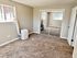 Bright bedroom with plush carpet, mirrored closet doors, and modern portable air conditioner for comfort and style.