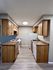 Inviting kitchen with warm wooden cabinets, sleek countertops, and modern appliances, perfect for culinary creativity.