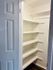 Immaculate walk-in pantry with ample shelving for optimal organization and storage.