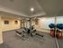 Modern fitness room with sleek exercise equipment and bright wall art, perfect for a dynamic workout.