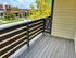 Charming balcony view with sleek railing overlooking a vibrant neighborhood and lush greenery.