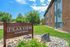 Inviting exterior view of Peakview Apartments, showcasing beautiful landscaping and clear blue skies.