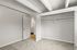 Bright bedroom with ample closet space, accented by elegant grey carpeting and exposed beam ceilings.