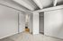 Bright and spacious bedroom with soft carpet flooring and ample closet space, leading to a modern bathroom.