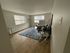 Inviting living room with elegant furnishings and ample natural light, featuring modern decor and sleek hardwood floors.