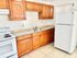 Bright and inviting kitchen with warm wooden cabinetry, modern appliances, and ample counter space.