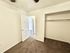Cozy bedroom with plush carpet and spacious closet, offering a warm and inviting atmosphere.