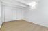 Bright and spacious empty room with elegant light wood flooring, white walls, and modern sliding closet doors.