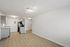 Bright, modern kitchen with sleek grey cabinets, stainless steel appliances, and inviting open layout.