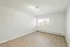 Bright and spacious room featuring elegant wood flooring and large windows for natural light.