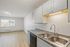 Bright and airy kitchen with white cabinets, sleek granite countertops, and modern sink offering a contemporary feel.