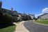 Charming townhouse complex with manicured lawns and a serene courtyard, perfect for modern living.