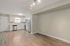 Modern open-concept kitchen with stainless steel appliances and elegant wood flooring, ideal for stylish living.