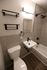 Modern bathroom featuring elegant tiling, sleek fixtures, and a stylish bathtub for a luxurious experience.