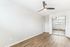 Bright, airy bedroom with sleek floors and mirrored closet doors, perfect for modern living.
