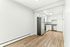 Bright, contemporary kitchen with sleek stainless steel appliances, modern white cabinetry, and elegant wood flooring, offering a perfect blend of style and functionality.
