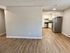 Modern open-plan kitchen area with sleek stainless steel appliances and warm wood flooring, perfect for contemporary living.