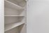 Spacious white pantry with multiple shelves offering ample storage for an organized kitchen.