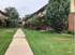 Charming apartment community with brick exteriors and lush green landscaping, perfect for a peaceful lifestyle.