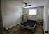 Bright and elegant bedroom with modern flooring, minimalist furniture, and ample natural light.