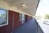 Inviting balcony with red brick exterior offering charming street views and abundant natural light, perfect for relaxation.
