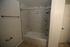 Elegant bathroom featuring a sleek marble-tiled shower and bathtub combination, offering a luxurious retreat.